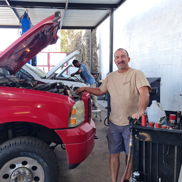 Chris Hardy next to red pickup at shop, 2510 East Bell Road, Phoenix, AZ 85032
